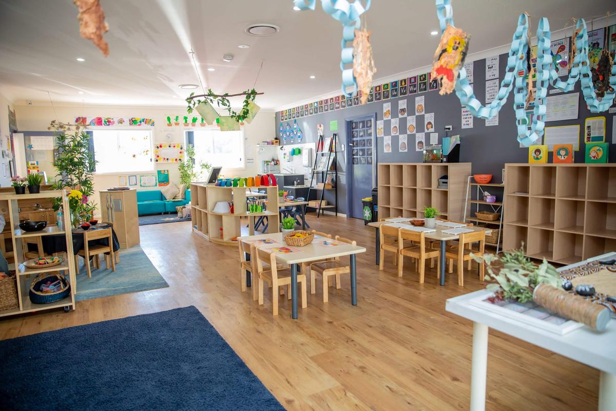 A team of happy childcare educators smiling together