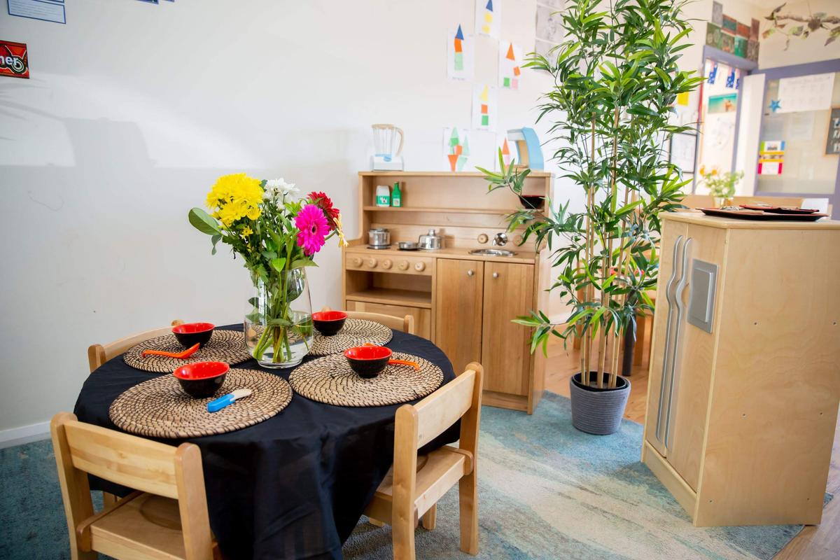 Two toddlers playing with colorful building blocks on the floor